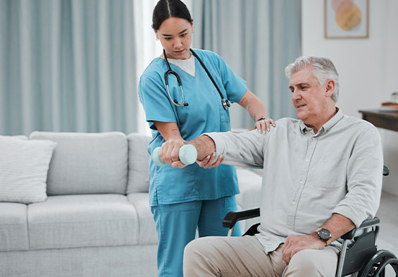 nurse aiding a man in a wheel chair